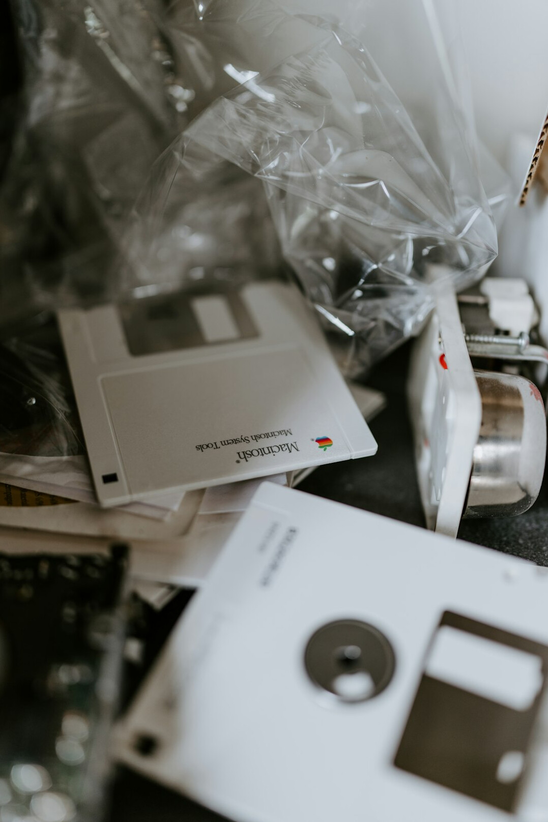 Flat lay of archival photographs, stamped index cards and a magnifying glass